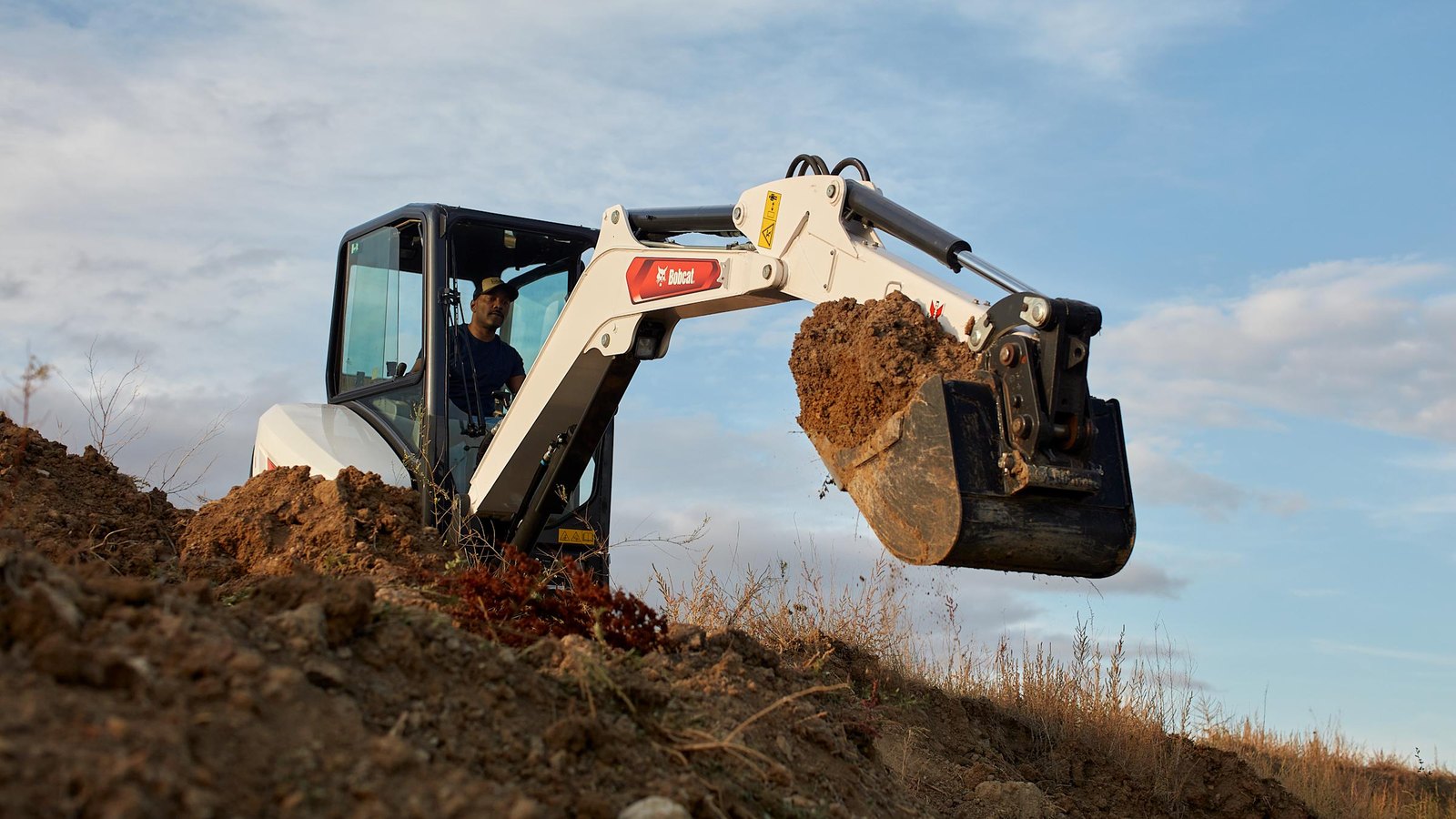 Bobcat E32 mini excavator digging &mdash; rent it from Crowder Rentals in Wheat Ridge
